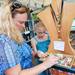 Kirsten Cochran shops with her daughter Brooke, 10, both of Midland, as they look through a selection of beads with inspirational words carved on them during the Guild's Ann Arbor Summer Art Fair on Thursday, July 18, 2013. Melanie Maxwell | AnnArbor.com